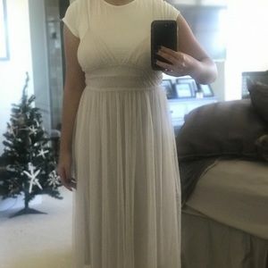 A sheer dress attached to a white slip dress.
